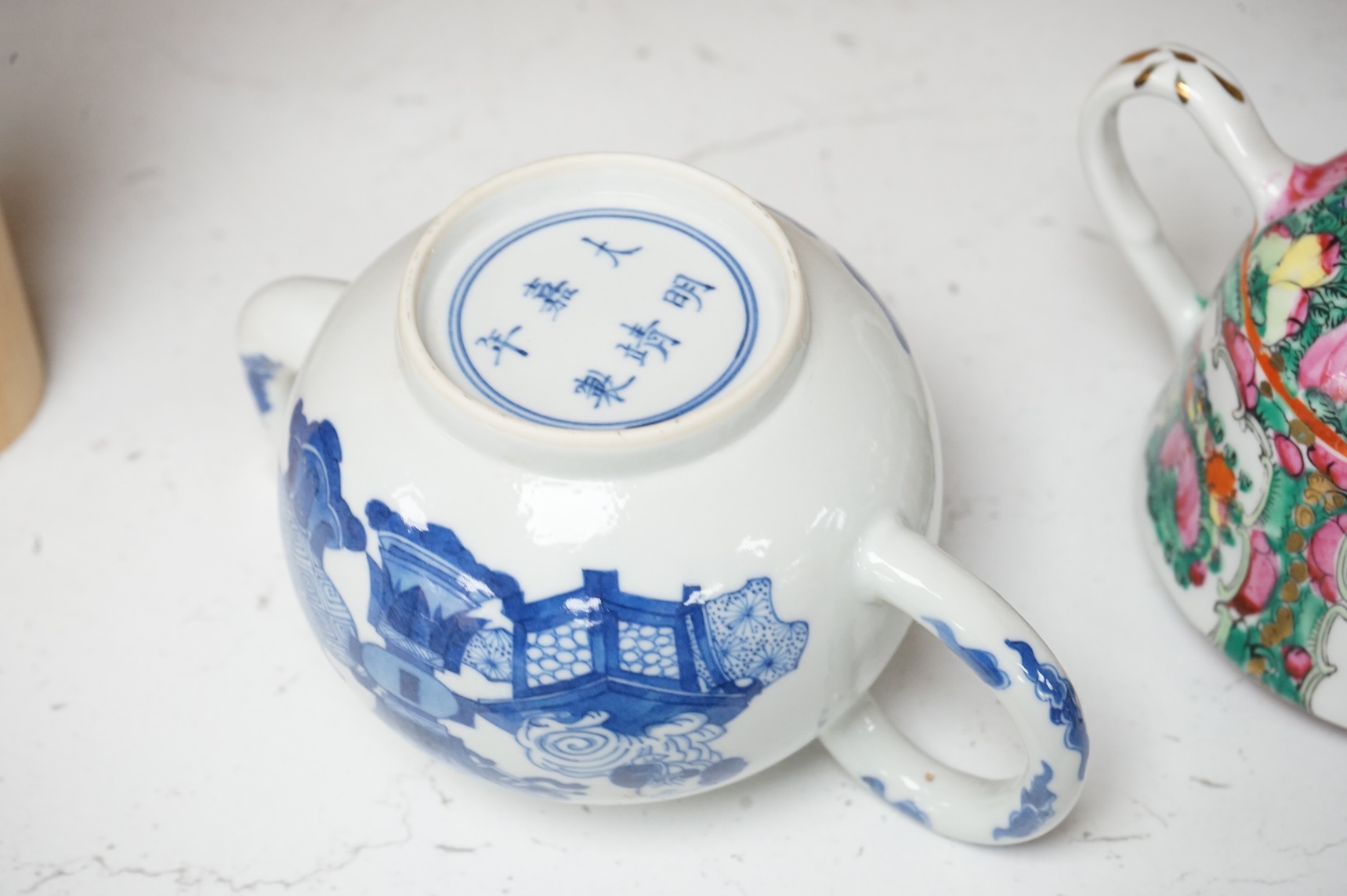 Two Chinese teapots comprising a blue and white and famille rose example, largest 16cm wide